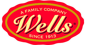 Wells logo in yellow writing with a red background